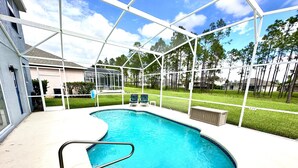 A swimming pool with a white deck and a safety railing. - Modern and Well Equipped 6/3 Pool Home on Golf Community. Perfectly accommodating for families with ample space inside and out! (Davenport)