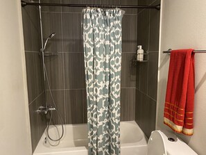 Combined shower/bathtub, towels, soap, toilet paper