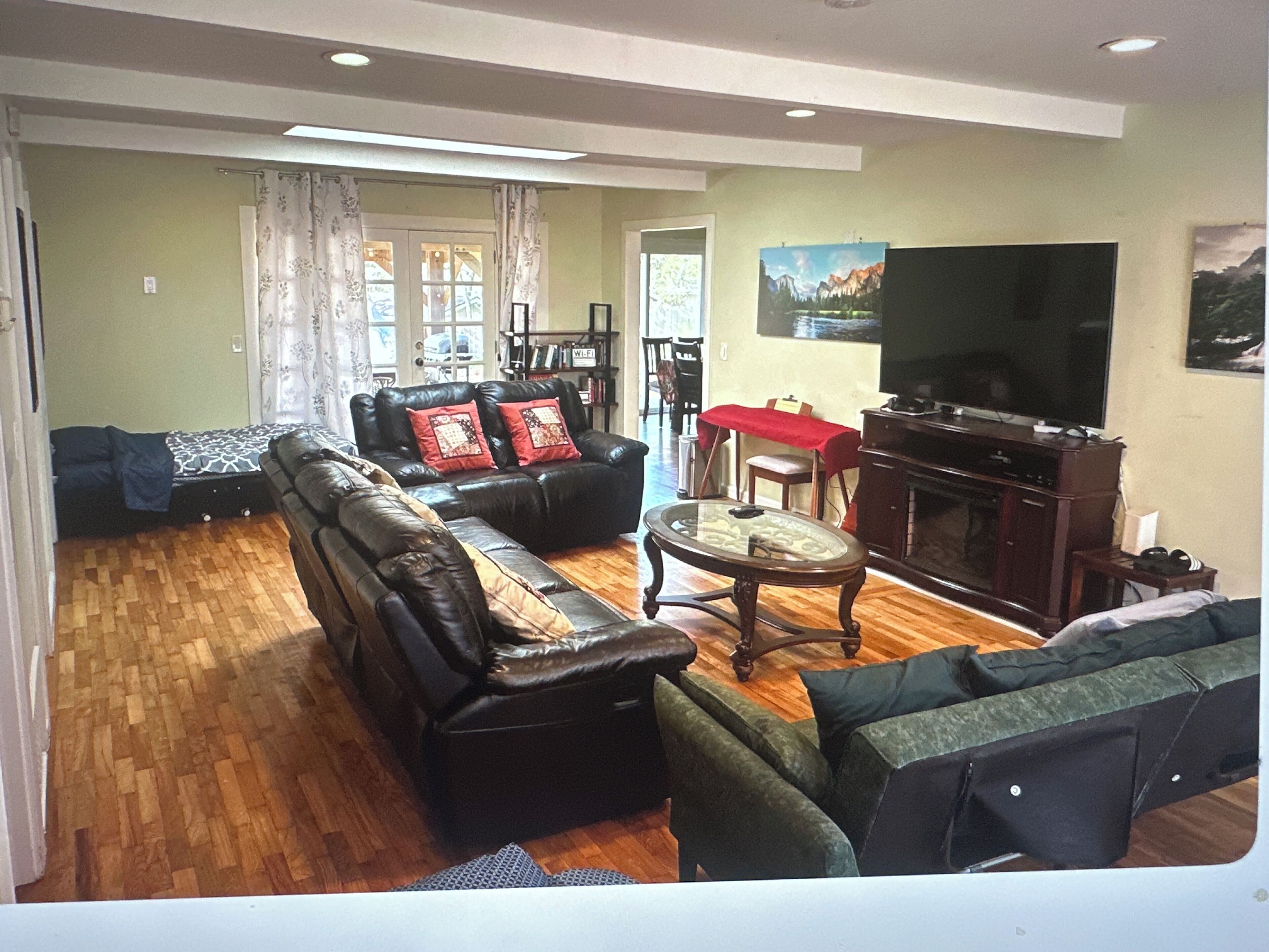 A living room with a sofa set, a television, and a fireplace.