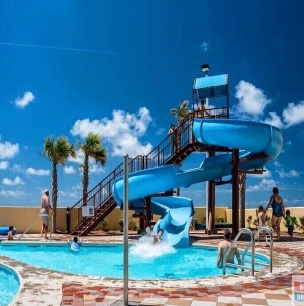 Enjoy a fun-filled day at the water park with a thrilling blue water slide.