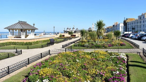 A coastal promenade with a gazebo, flower beds, and a view of the sea and buildings. - Elegant 2 Bed Georgian Apartment in Herne Bay (Herne Bay)