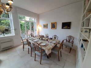 Enjoy meals with friends and family at this dining room, featuring a large table and comfortable seating for six.