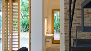 A modern bathroom with a bathtub, a sink, and a window.
