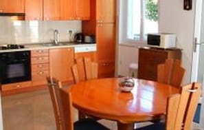 Efficient kitchen with a central island, microwave, sink, and stove.