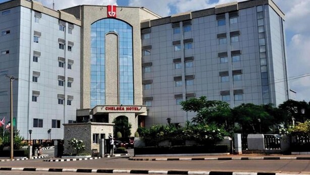 A multi-story building with a prominent entrance labeled 'Chelsea Hotel.' - Room-chelsea Hotel - Guest Room (Abuja)