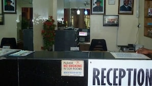 A reception area with a sign indicating no smoking in the rooms and a reception desk. - Room-definite Destiny Hotel - Guest Roo (Asaba)