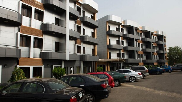 A multi-story parking garage with cars parked in rows. - Room-grand Ibro Hotel - Guest Room (Abuja)