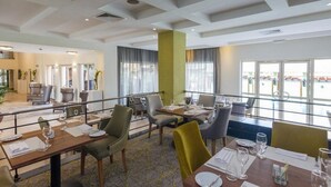 A hotel dining area with tables, chairs, and a view of the outside. - Room-leola Hotel, Lagos-guest Room (Lagos)