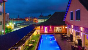 A rooftop pool with a view of the cityscape at dusk. - Room-leola Hotel, Lagos-guest Room (Lagos)