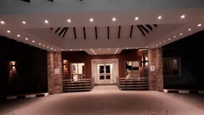 A hotel entrance with a central staircase, stone pillars, and a modern ceiling design. - Room-leola Hotel, Lagos-guest Room (Lagos)