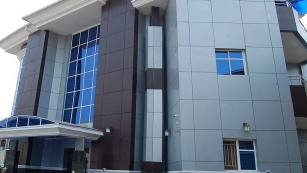 A modern building with large windows, a flat roof, and a symmetrical facade. - Room-royal Park Hotel & Suite - Guest Ro (Asaba)