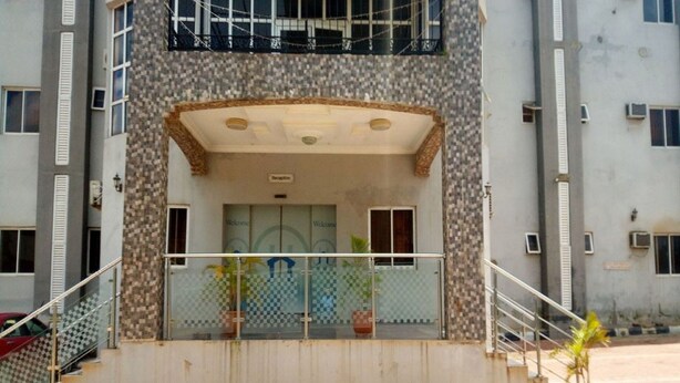 A building entrance with a covered area, steps, and a railing. - Room-wetland Hotels, Ibadan-guest Room (Ibadan)