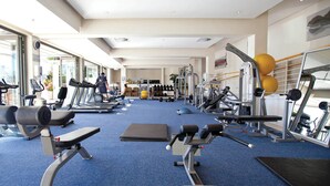 A gym with treadmills, weight machines, and exercise balls. - Luxury Three Bedroom Apartment - Fully Furnished and Equipped (Cape Town)