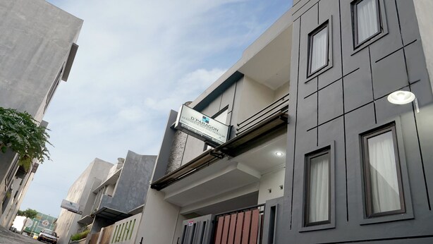 A modern building with a sign indicating 'D'Paragon' and a gated entrance. - Dparagon Pamela 4 (Depok)
