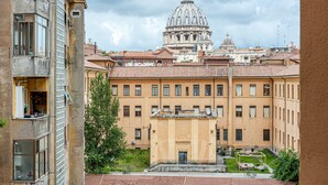 A building with a large dome and a courtyard with a fountain.