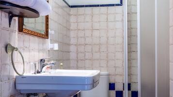 A bathroom with a sink, toilet, and shower.