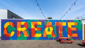 A colorful wall with the word 'CREATE' painted in large letters.