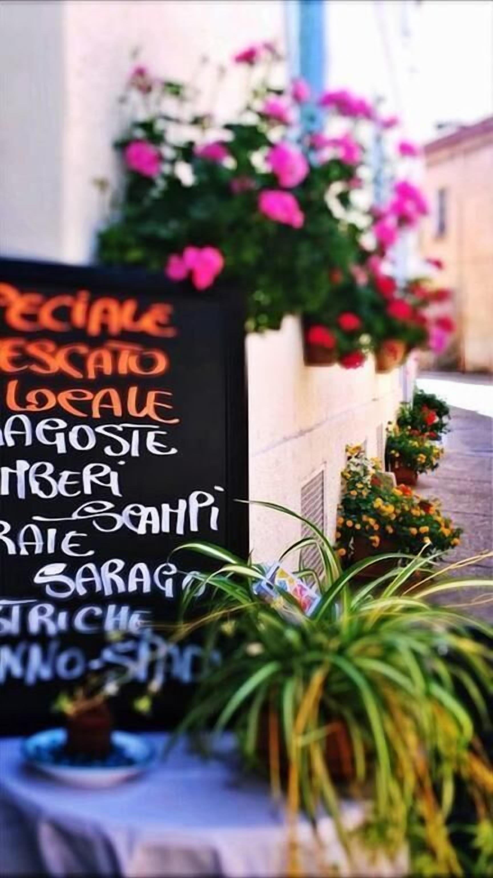 A blackboard with a list of food items written in white chalk.