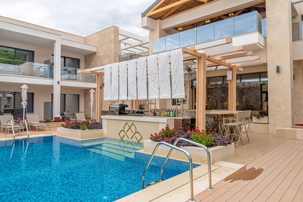 Seasonal outdoor pool, open 10:00 AM to 8:00 PM, pool umbrellas