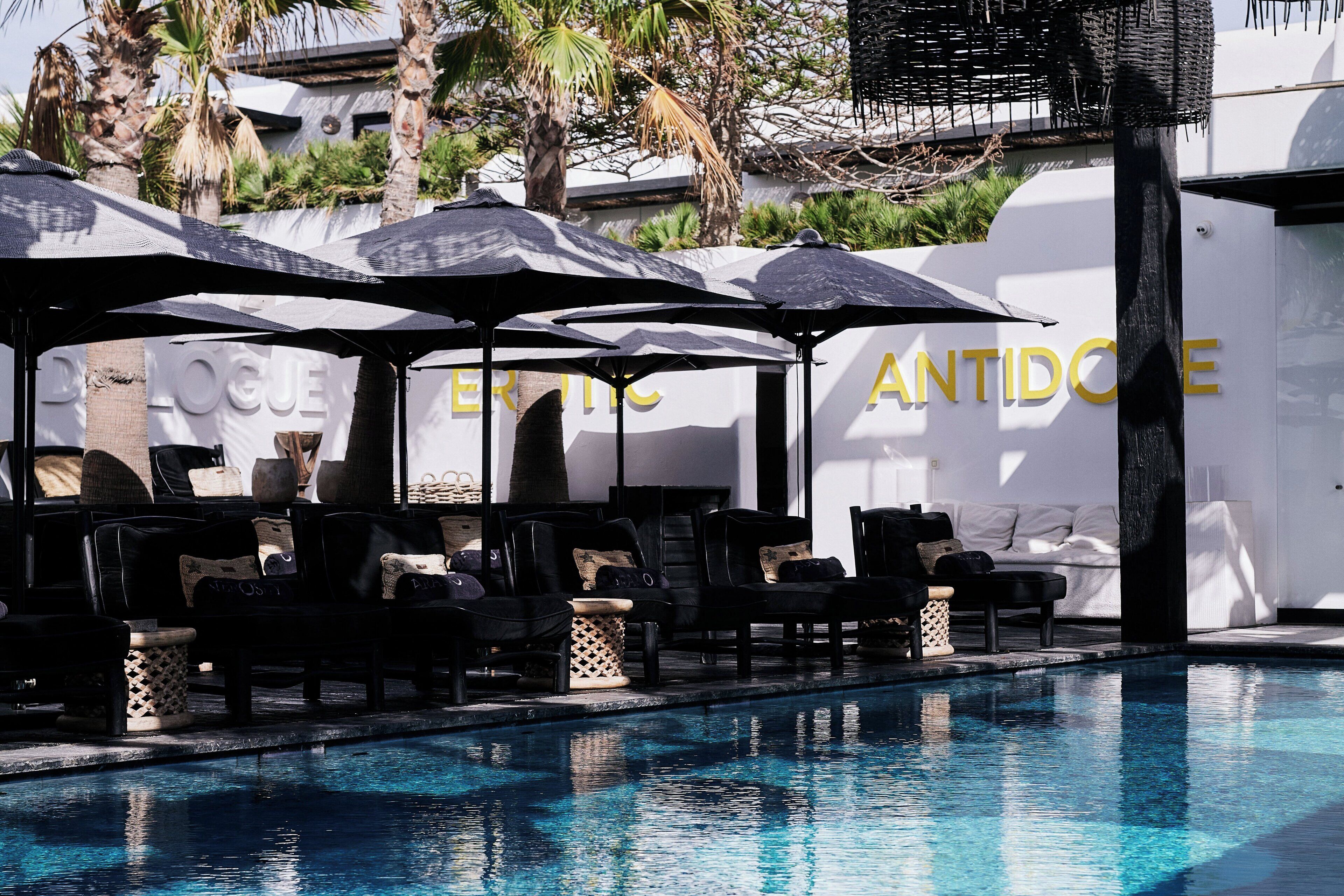 Seasonal outdoor pool, open 11:00 AM to 8:00 PM, pool umbrellas