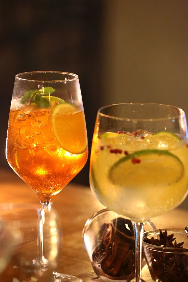 Two glasses of beverages on a table with a blurred background.