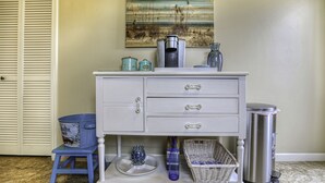 A white dresser with drawers, a small stool, a trash can, and a basket on a table. - Adorable Dog Friendly Vacation Home in Grover Beach (Grover Beach)