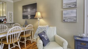 A dining area with a table, chairs, a lamp, and artwork on the wall. - Adorable Dog Friendly Vacation Home in Grover Beach (Grover Beach)