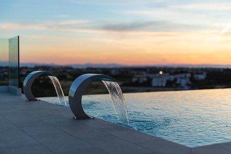 Seasonal outdoor pool, open 9:00 AM to 7:00 PM, sun loungers