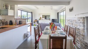 A modern kitchen with a dining area.