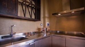 A modern kitchen with stainless steel appliances, a wooden-framed window, and a built-in oven. - Private villa with pool with panoramic view inside organic wine resort (Arezzo)