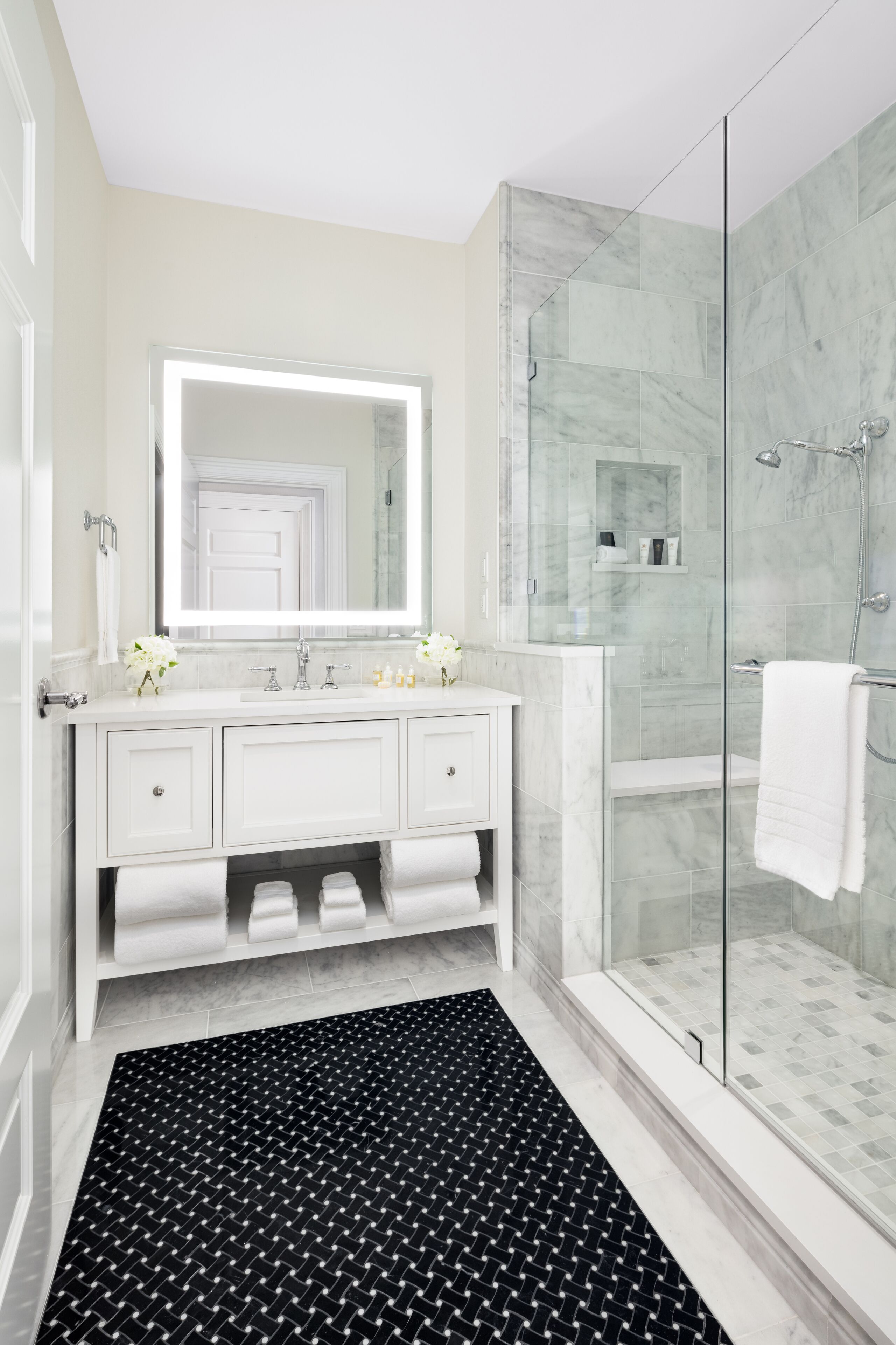 designer toiletries, hair dryer, slippers, towels