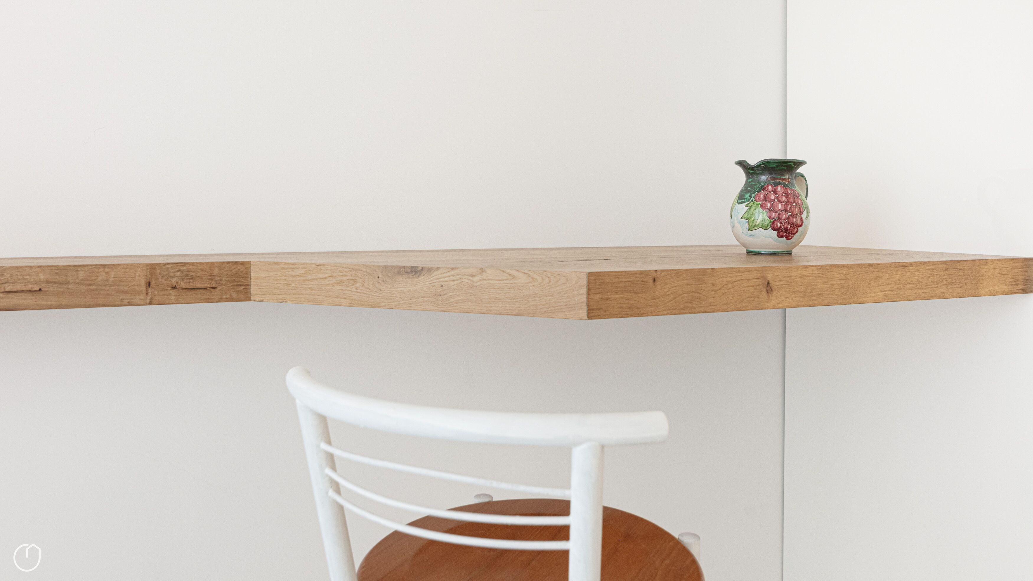 A wooden shelf with a decorative vase.