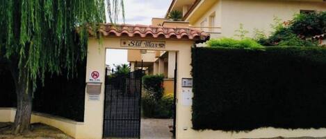 A gated entrance to a building with a sign reading "Still Mar".