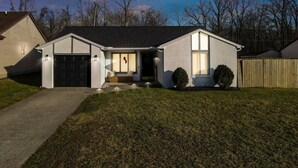 A single-story house with a garage, a front porch, and a small front yard. - Easy Livin` By Easton: Hot tub, Family Friendly, 6 minutes from Easton Town Center (Columbus)