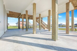 Stunning hall with high ceilings, wooden beams, and expansive windows offering views of the surrounding neighborhood.