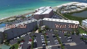 An aerial view of a hotel with a parking lot, a pool, and a beach in the background. - Fun & Easy Access to Everything! Islander 216 (Destin)