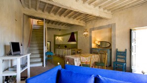 A room with a staircase, a dining area, and a blue sofa. - View on the Vally (Cetona)