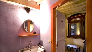 A bathroom with a sink, mirror, and shelf. - View on the Vally (Cetona)