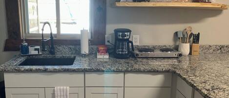 Microwave, stovetop, coffee/tea maker, cookware/dishes/utensils