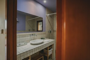 Bathtub, hair dryer, towels, toilet paper