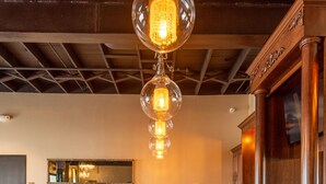 A conference room with a long table, chairs, and a chandelier. - Hotel 21 & Co. (Gering)
