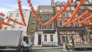 A building with a sign for 'Galaxy Hair London' and a white truck parked in front. - Gerrard Place by Aeria Apartments (London)