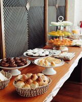 Una mesa de buffet con diversos productos horneados y pasteles.