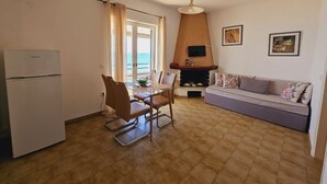 A compact living space with a kitchenette, dining area, and seating area. - Corfu Dream Holidays  Apartments (Corfu)