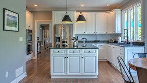 A modern kitchen with white cabinetry, a wooden ceiling, and pendant lighting. - Luxury Estate w/ Hot Tub & Game Room + Biltmore Pass | 18 Min to Asheville (Asheville)