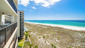 A high-rise building with a balcony overlooking a beach. - Relax by the Gulf in Luxury! Phoenix VI 61010 (Orange Beach)