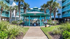 A pool and gazebo area with a sign indicating it's for guests only.
