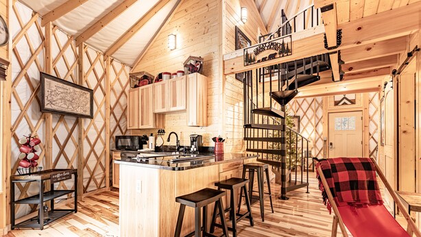 A cozy cabin interior with a kitchen, dining area, and a red slide. - Lush Comfort, great for couples or small family, Huge Deck w/Privte Hot Tub (Pigeon Forge)