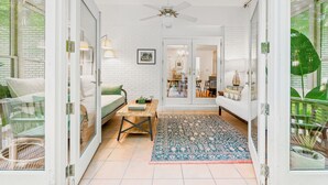 A spacious living area with a sofa, coffee table, and a patterned rug.