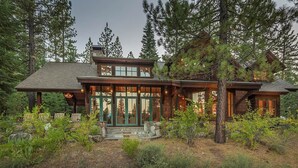 A large, rustic log cabin with a prominent front porch and multiple windows. - MONTHLY LEASE - Luxury 4 BR 4 BA Truckee Available March 2022 (Truckee)